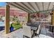 Covered patio with an outdoor dining set and hillside landscaping, creating a relaxing entertainment space at 5635 Mesa Mountain Dr, Las Vegas, NV 89135