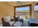 A comfortable covered patio featuring cushioned chairs and an outdoor view at 5635 Mesa Mountain Dr, Las Vegas, NV 89135