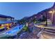 Stunning backyard with refreshing pool, lush landscaping, and comfortable lounge area against a beautiful mountain view at 5635 Mesa Mountain Dr, Las Vegas, NV 89135