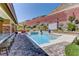 Luxurious swimming pool with waterfall feature and lush landscaping, creating a serene outdoor oasis at 5635 Mesa Mountain Dr, Las Vegas, NV 89135