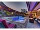 Luxurious backyard with a pool, integrated spa, outdoor kitchen, and cozy seating areas for ultimate relaxation and entertainment at 5635 Mesa Mountain Dr, Las Vegas, NV 89135