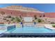 Backyard pool with a waterfall, spa, and professionally landscaped surrounding areas at 5635 Mesa Mountain Dr, Las Vegas, NV 89135