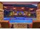 Backyard pool with outdoor TV, fire bowls, and comfortable lounge seating, creating a perfect entertainment space at 5635 Mesa Mountain Dr, Las Vegas, NV 89135