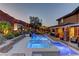 Picturesque pool area featuring integrated spa, custom stonework, and a covered patio with seating, perfect for outdoor enjoyment at 5635 Mesa Mountain Dr, Las Vegas, NV 89135