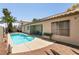 Secluded backyard with a refreshing pool and a cozy seating area at 5824 Kane Holly St, Las Vegas, NV 89130