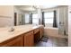 This bright bathroom features dual sinks, tile floors, and a separate tub and shower at 5824 Kane Holly St, Las Vegas, NV 89130