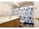 Charming bathroom featuring a light wood vanity and a fun shower curtain at 5824 Kane Holly St, Las Vegas, NV 89130
