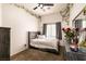 A cozy bedroom with vine decor, grey wood bedframe, and natural light at 5824 Kane Holly St, Las Vegas, NV 89130