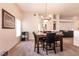 View of a dining area featuring an elegant chandelier and adjacent living space at 5824 Kane Holly St, Las Vegas, NV 89130