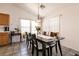 Bright dining room features a decorative chandelier and lots of sunlight from large windows at 5824 Kane Holly St, Las Vegas, NV 89130