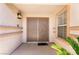 Covered front entryway featuring a security screen door and decorative accents at 5824 Kane Holly St, Las Vegas, NV 89130