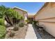Landscaped front yard with a walkway leading to the charming front entrance at 5824 Kane Holly St, Las Vegas, NV 89130