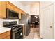 Efficient kitchen layout with stainless steel appliances and tile flooring at 5824 Kane Holly St, Las Vegas, NV 89130