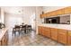 Spacious kitchen with tile flooring, wooden cabinets, and an adjacent dining area at 5824 Kane Holly St, Las Vegas, NV 89130