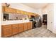 Spacious kitchen showcasing wood cabinetry, stainless steel appliances, and an open view into the dining area at 5824 Kane Holly St, Las Vegas, NV 89130