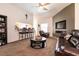 Inviting living room features carpet, bar seating, ceiling fan, and a stone fireplace at 5824 Kane Holly St, Las Vegas, NV 89130