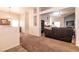 Open-concept living room with carpet, bright lighting, and neutral wall paint at 5824 Kane Holly St, Las Vegas, NV 89130