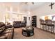 Open-concept living room with comfortable seating, breakfast bar, and access to other areas at 5824 Kane Holly St, Las Vegas, NV 89130