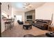 Spacious living room with a wet bar, fireplace, ceiling fan, and comfortable seating at 5824 Kane Holly St, Las Vegas, NV 89130