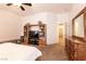 A lovely main bedroom with wooden dresser, ceiling fan, and neutral colored carpet flooring at 5824 Kane Holly St, Las Vegas, NV 89130