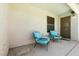 Covered patio featuring two cushioned chairs, providing a relaxing outdoor space with access to the house at 5824 Kane Holly St, Las Vegas, NV 89130