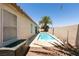 Private backyard pool with bright blue water and desert landscaping and privacy wall around property at 5824 Kane Holly St, Las Vegas, NV 89130