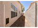 Side yard view showing home exterior with windows, a wall, and low maintenance landscaping at 5824 Kane Holly St, Las Vegas, NV 89130