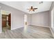 Spacious bedroom with wood-look flooring, natural light, and an arched doorway to an adjacent room at 5931 Allanche Ave, Las Vegas, NV 89141