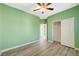 Empty bedroom featuring a ceiling fan, fresh paint, modern flooring, and a closet at 5931 Allanche Ave, Las Vegas, NV 89141