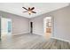 Bright bedroom with wood-look floors, archway and ceiling fan offering space and comfort at 5931 Allanche Ave, Las Vegas, NV 89141