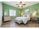 Cozy staged bedroom with furniture and green-colored walls, showcasing a relaxing atmosphere at 5931 Allanche Ave, Las Vegas, NV 89141