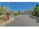 Gated entrance to community with well-maintained landscaping and elegant stone pillars at 5931 Allanche Ave, Las Vegas, NV 89141