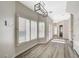 Bright dining room with wood floors, modern lighting, and views of the front yard at 5931 Allanche Ave, Las Vegas, NV 89141
