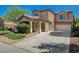 Inviting two-story home with a covered porch, manicured landscaping, and a spacious driveway leading to the garage at 5931 Allanche Ave, Las Vegas, NV 89141
