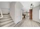 Open-concept foyer with wood floors, staircase, and view of the adjacent kitchen at 5931 Allanche Ave, Las Vegas, NV 89141