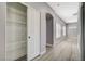 Hallway view featuring a modern closet with shelves, wood flooring, and neutral colors at 5931 Allanche Ave, Las Vegas, NV 89141