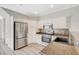 Well-lit kitchen features stainless steel appliances, white cabinets and granite countertops at 5931 Allanche Ave, Las Vegas, NV 89141