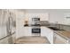 Modern kitchen featuring stainless steel appliances, granite countertops, and white cabinets at 5931 Allanche Ave, Las Vegas, NV 89141
