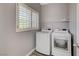 Bright laundry room with a modern washer and dryer, complemented by stylish window shutters and a shelf at 5931 Allanche Ave, Las Vegas, NV 89141