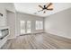 Open living room features an electric fireplace, ceiling fan, French doors and neutral tones at 5931 Allanche Ave, Las Vegas, NV 89141
