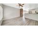 Open floor plan view of living room and kitchen with breakfast bar and brick accent wall at 5931 Allanche Ave, Las Vegas, NV 89141