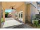 Covered patio with ceiling fan, brick flooring, and double door access to the house at 5931 Allanche Ave, Las Vegas, NV 89141