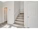 Bright stairway featuring wood-look steps and white walls, leading to the upper level of the home at 5931 Allanche Ave, Las Vegas, NV 89141