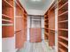 Spacious walk-in closet with custom wood shelving and drawers for optimal storage and organization at 5931 Allanche Ave, Las Vegas, NV 89141