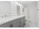 Well-lit bathroom featuring a double vanity with marble countertop and tub-shower combination at 600 Beresford Ave, Las Vegas, NV 89123