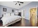Comfortable bedroom with dark wood floors and access to the ensuite bathroom at 600 Beresford Ave, Las Vegas, NV 89123