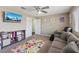 Bright bedroom with a ceiling fan, a large window, carpeted floors, and playful decor at 600 Beresford Ave, Las Vegas, NV 89123