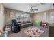 Comfortable bedroom featuring a ceiling fan, a large window and carpeted floors at 600 Beresford Ave, Las Vegas, NV 89123