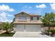 Charming two-story home featuring a three-car garage, desert landscaping, and a tile roof at 600 Beresford Ave, Las Vegas, NV 89123