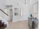Bright foyer featuring tile flooring, staircase, and stylish decorative accents, creating a welcoming entrance at 600 Beresford Ave, Las Vegas, NV 89123